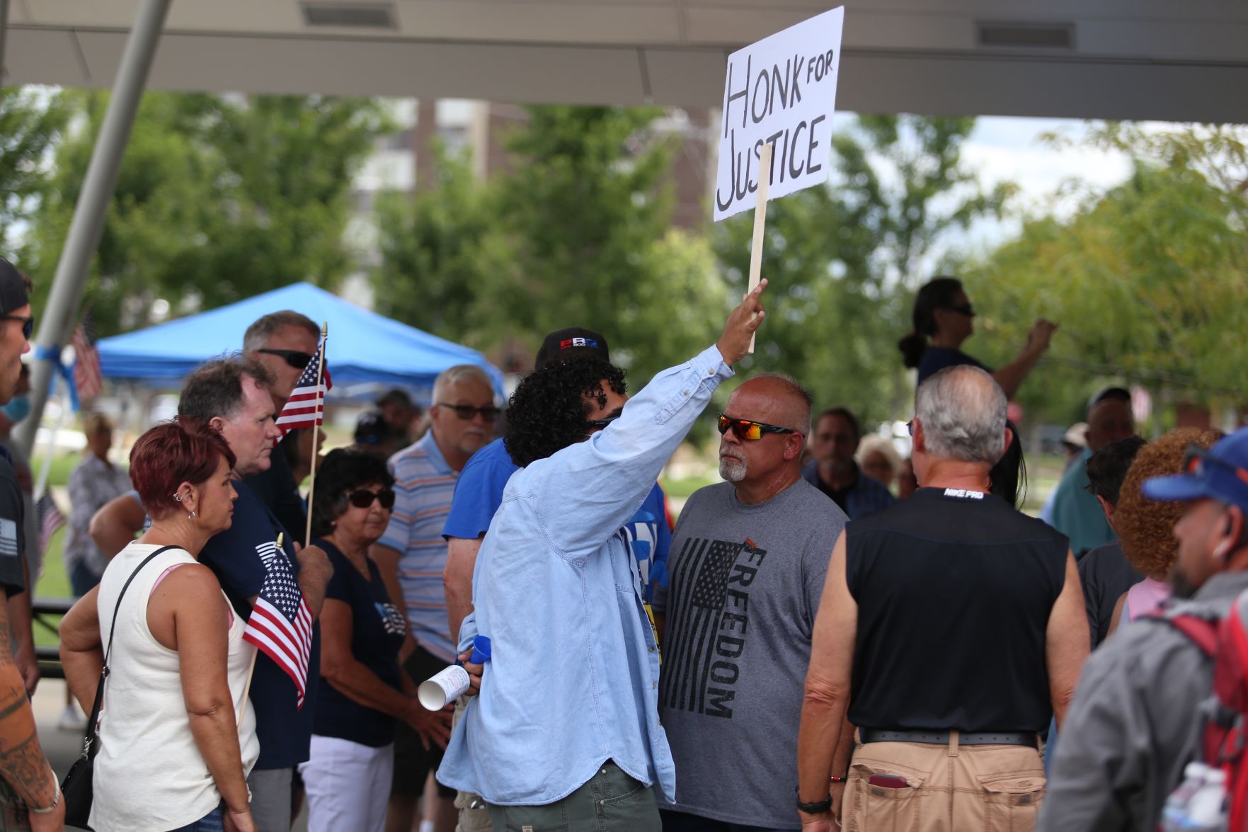Speakers 'Back the Blue' during rally as protesters continue calls for ...