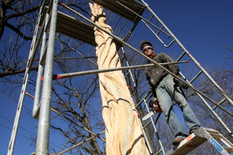 Sculpting stumps Chain saw artist creating sculpture on Utica Pike