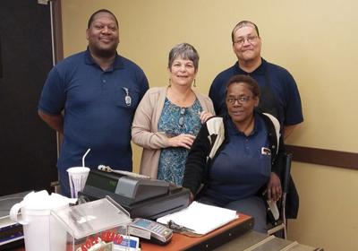 Food service team members (from left) Tony Jones, Sue DiPiazza, Wanda Bradley and Wayne Santiago begin work before dawn to prepare and deliver meals to senior and day care centers across Monroe County.