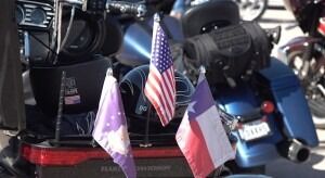 flags-on-the-back-of-a-motorcycle-participating-in-the-dakota-thunder-run-300×164-1