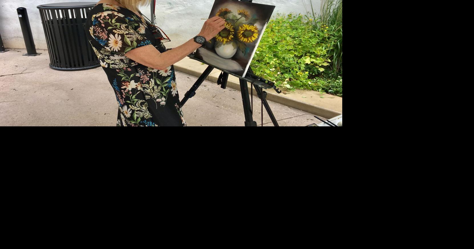 Artist brightens Ilumination Station with sunflower painting