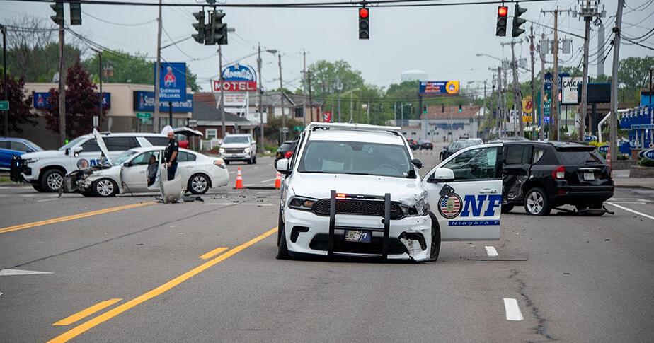 Falls Police Crash Management Unit investigators probe cause of three car accident involving police crusier - Vimarsana News