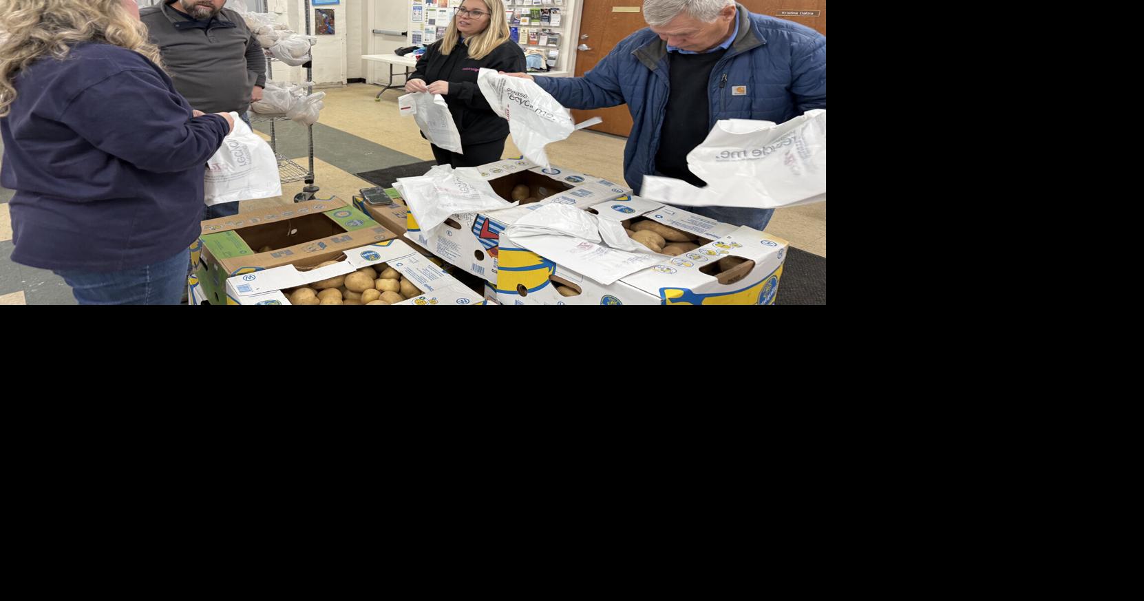 National Grid volunteers hand out holiday meal items at Heart Love & Soul