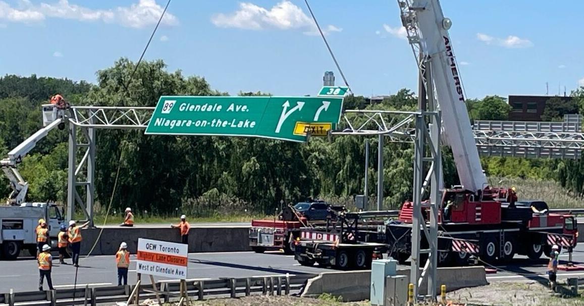 Section of QEW closed to clear sign struck by dump truck