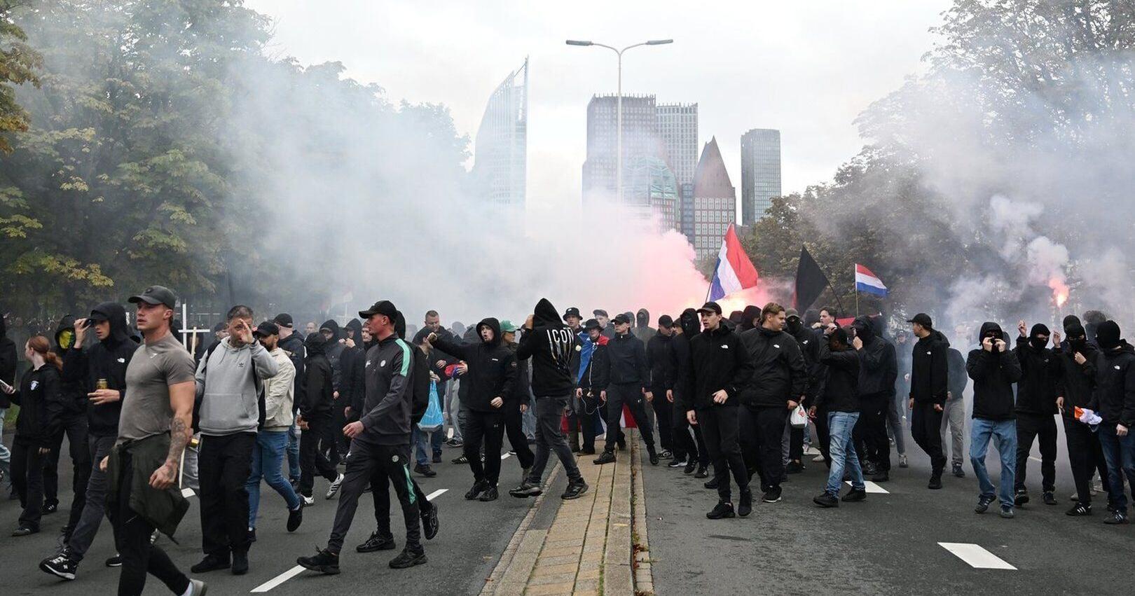 Dutch riot police break up far - right protest in The Hague after violence erupts