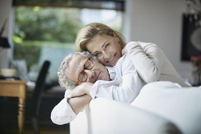 Mature couple cuddling at home