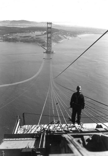 Construction on the Golden Gate Bridge lasted from 1933 to 1937. A year before its completion, a worker stands on the north tower, which is 746 feet tall, and looks out toward the south tower and San Francisco. | Photo courtesy of Highway And Transporta...