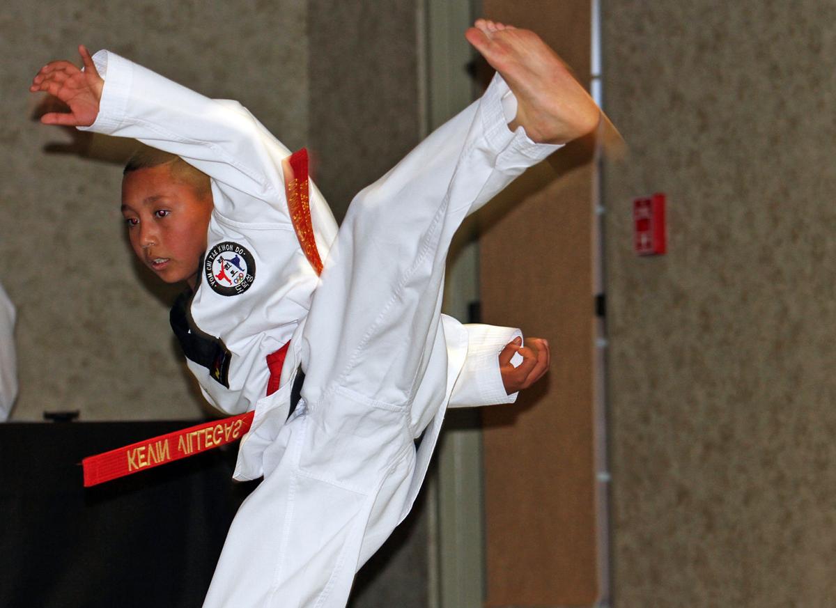 Brothers earn taekwondo black belts; 14 more advance