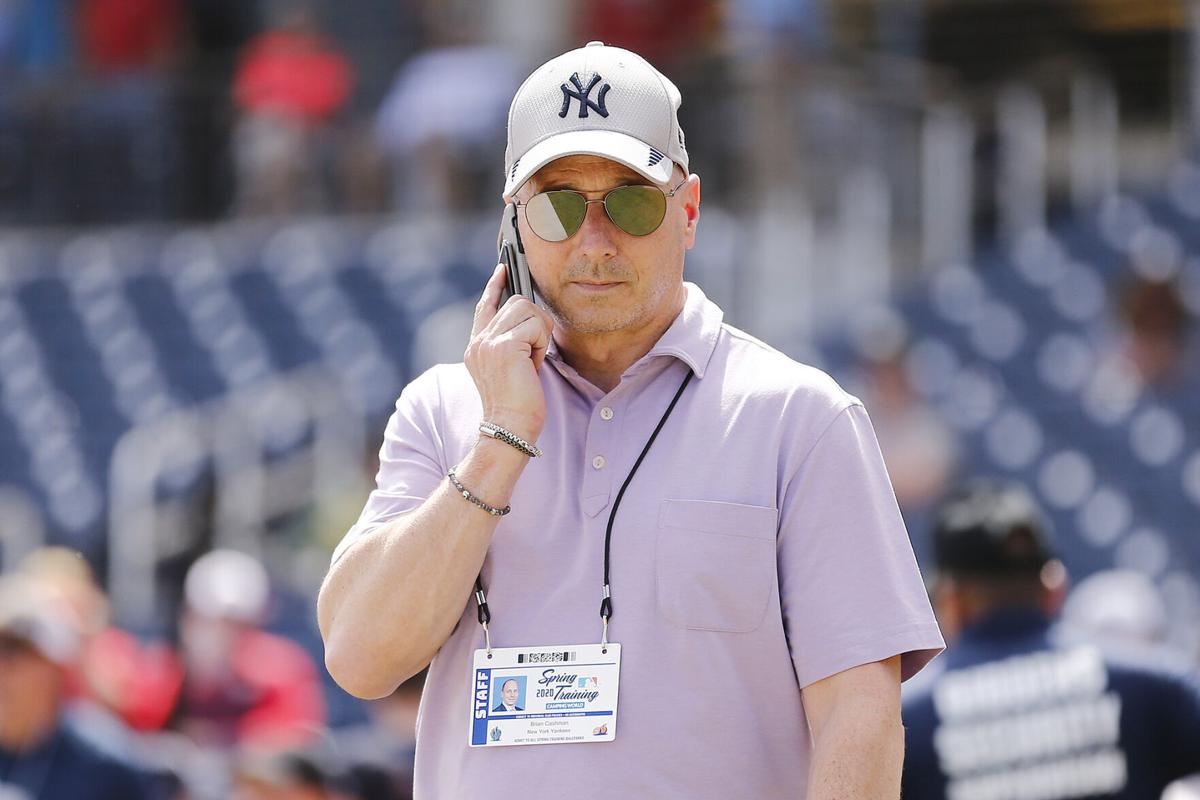 In this photo from March 12, 2020, New York Yankees general manager Brian Cashman talks on the phone prior to a Grapefruit League spring training game between the Washington Nationals and the New York Yankees at FITTEAM Ballpark of The Palm Beaches in West Palm Beach, Florida.