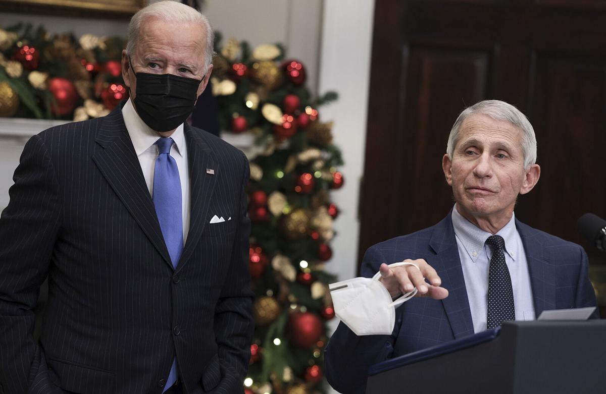 Anthony Fauci, Director of the National Institute of Allergy and Infectious Diseases and Chief Medical Advisor to the President, speaks alongside U.S. President Joe Biden as he delivers remarks on the Omicron COVID-19 variant following a meeting of the ...
