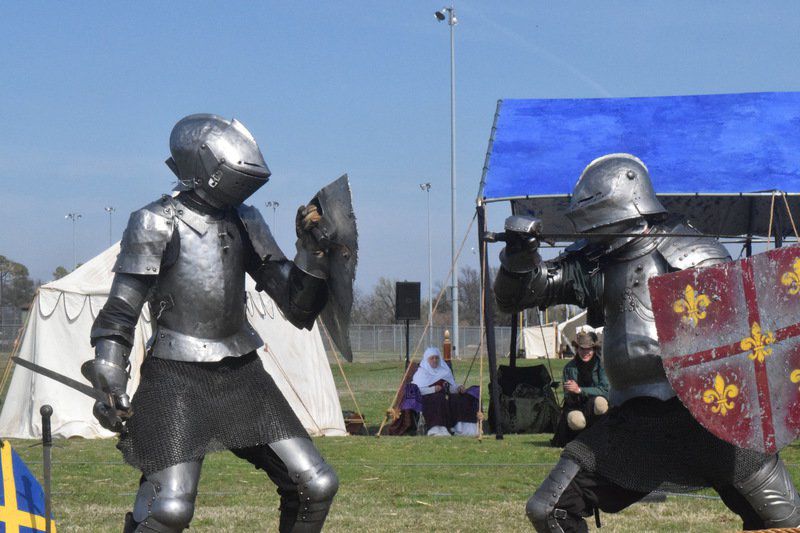 Two knights in armor fighting a duel with lances in a