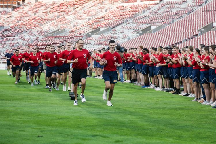 PHOTOS OU Naval ROTC runs a game ball to the Cotton Bowl ahead of Red