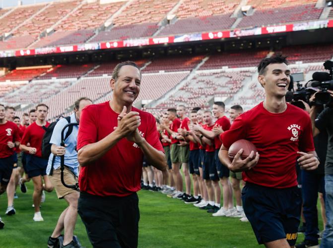 PHOTOS OU Naval ROTC runs a game ball to the Cotton Bowl ahead of Red