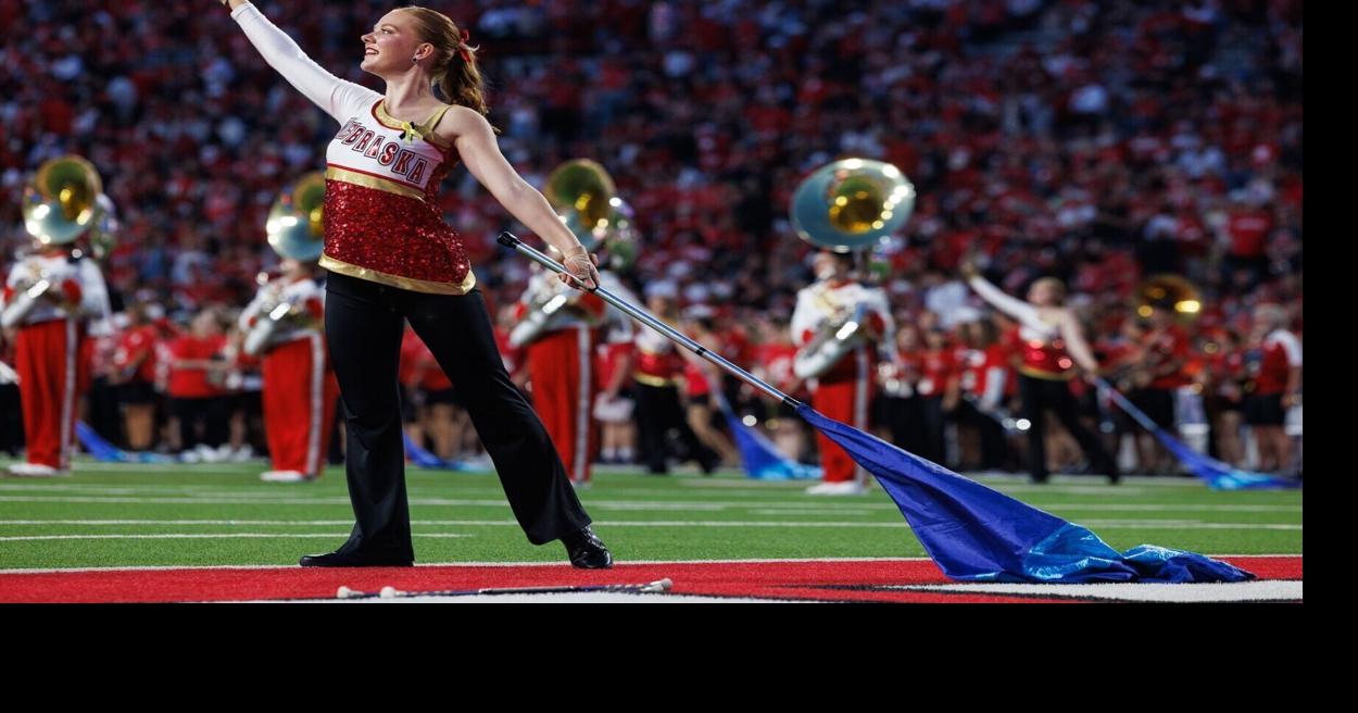 Nebraska marching band dons black and gold to honor late Iowa student at halftime