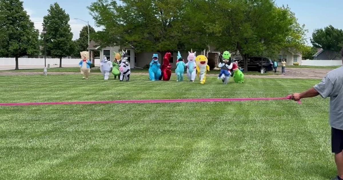 Linden Estates staff race wearing inflatable costumes