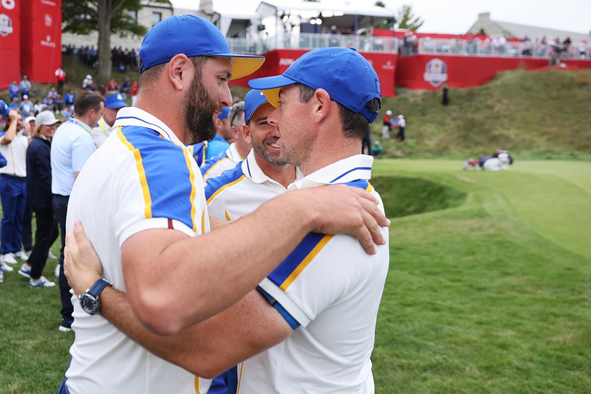 Team Europe members Jon Rahm of Spain, Sergio Garcia of Spain and Rory McIlroy of Northern Ireland embrace after Team United States defeated Team Europe 19 to 9 during Sunday Singles Matches of the 43rd Ryder Cup at Whistling Straits on September 26, 2021 in Kohler, Wisconsin.