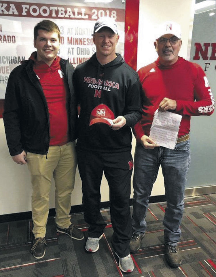 Scott Frost signs hat after cousin of 