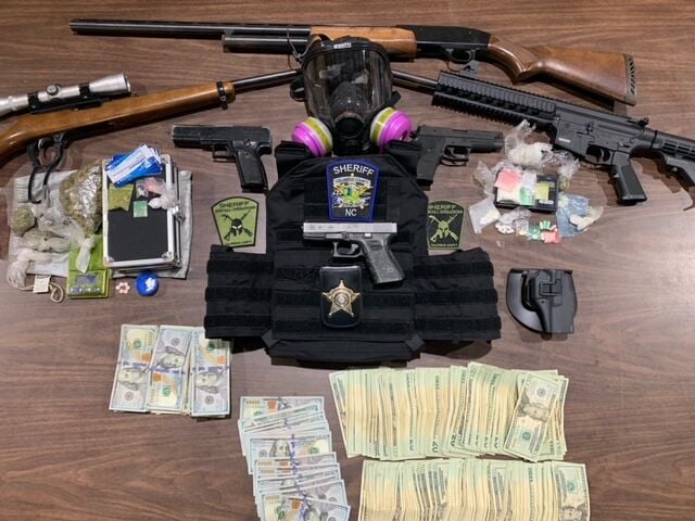 Gas mask drugs guns seized during raid outside Tabor City News