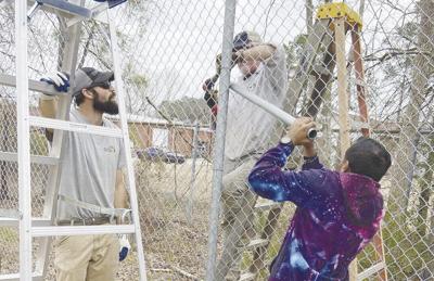 Shizzy's Wildcat Rescue volunteers build fence