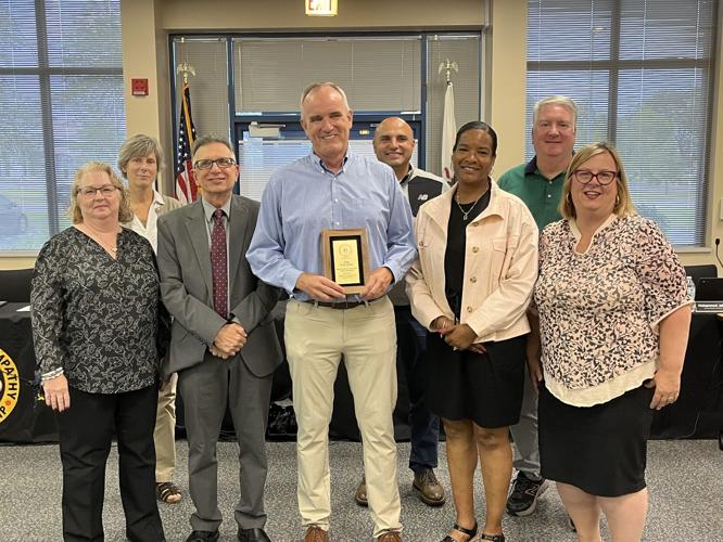 Andrew assistant principal honored; District 210 retools