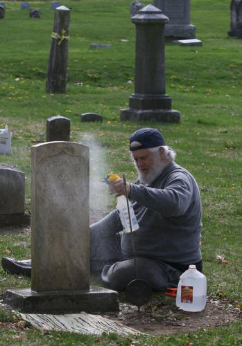 Grand Bay boy cleaning up gravesites at local cemetery