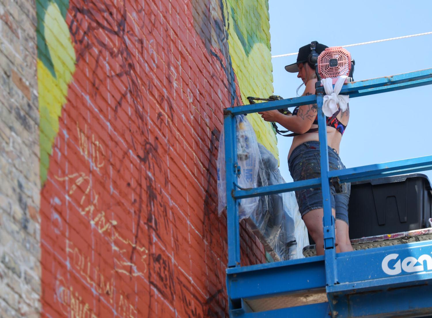 Leaving their mark | Mural artists ride the lift and paint LaPorte