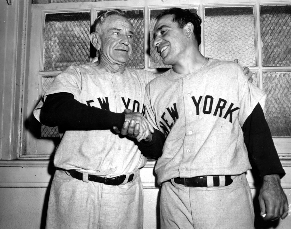 New York Yankees Hall of Famers Yogi Berra and Whitey Ford (R) reacts to  fan's cheers on a golf cart during Old-Timers Day ceremonies before the  Yankees played the Tampa Bay Rays