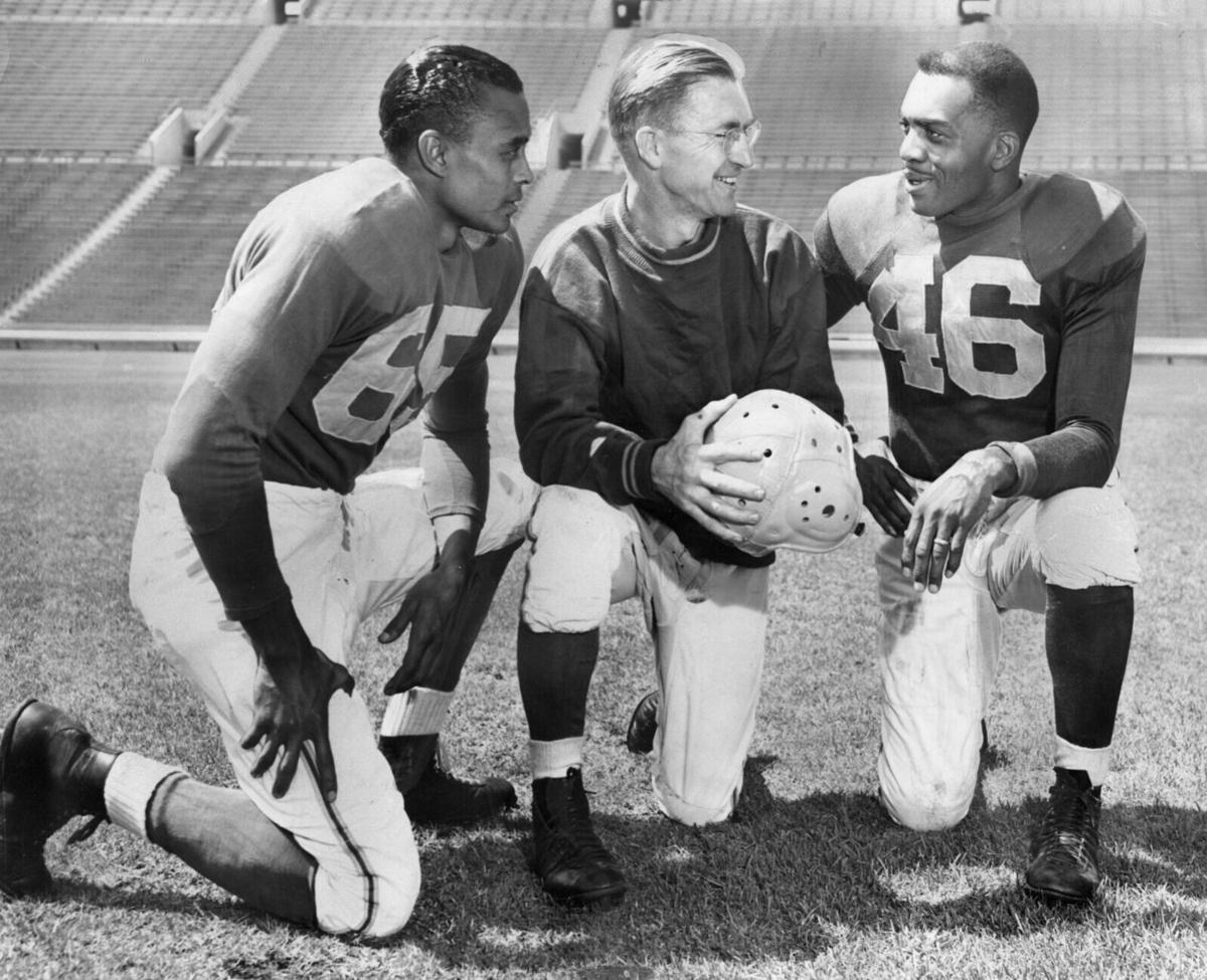 Ex-UCLA Bruins Woody Strode, left, and Kenny Washington, right, listen to Los Angeles Rams coach Adam Walsh in a publicity photo taken at the Memorial Coliseum, published September 7, 1946 in the Los Angeles Times.