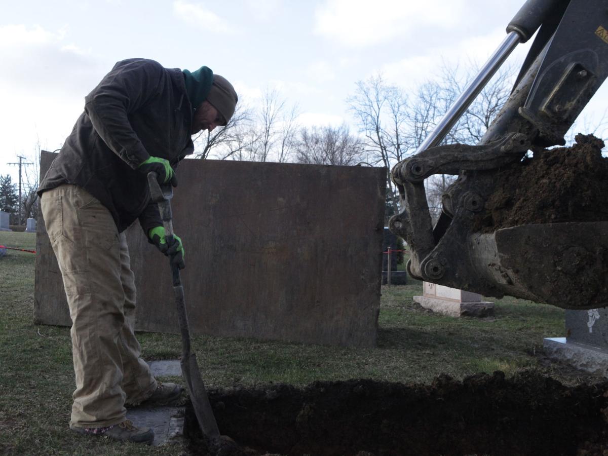 Someone's got to do it Gravediggers are subtle figures behind cemetery