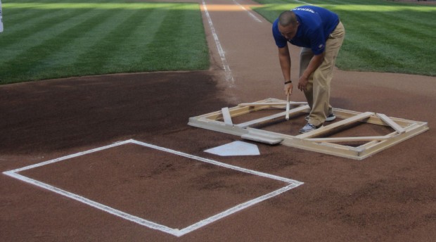 Chicago Cubs players celebrate at home plate around Darwin Barney