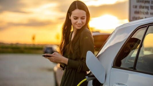 EV charging woman