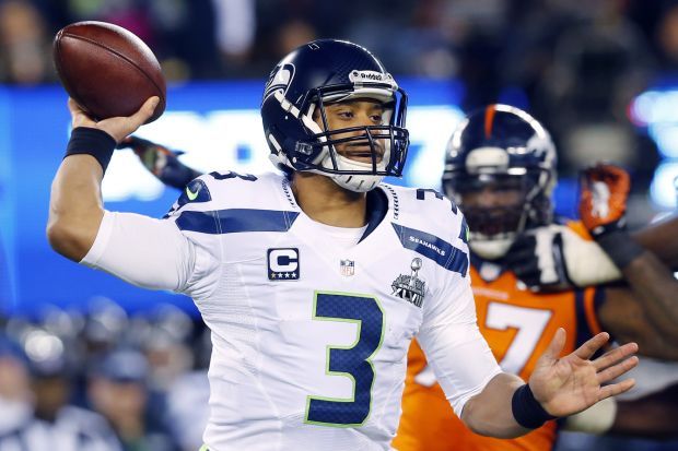 Seattle Seahawks quarterback Russell Wilson holds the Vince Lombardi trophy  after winning Super Bowl XLVIII at MetLife Stadium in East Rutherford, New  Jersey on February 2, 2014. Seattle beat Denver 43-8 to