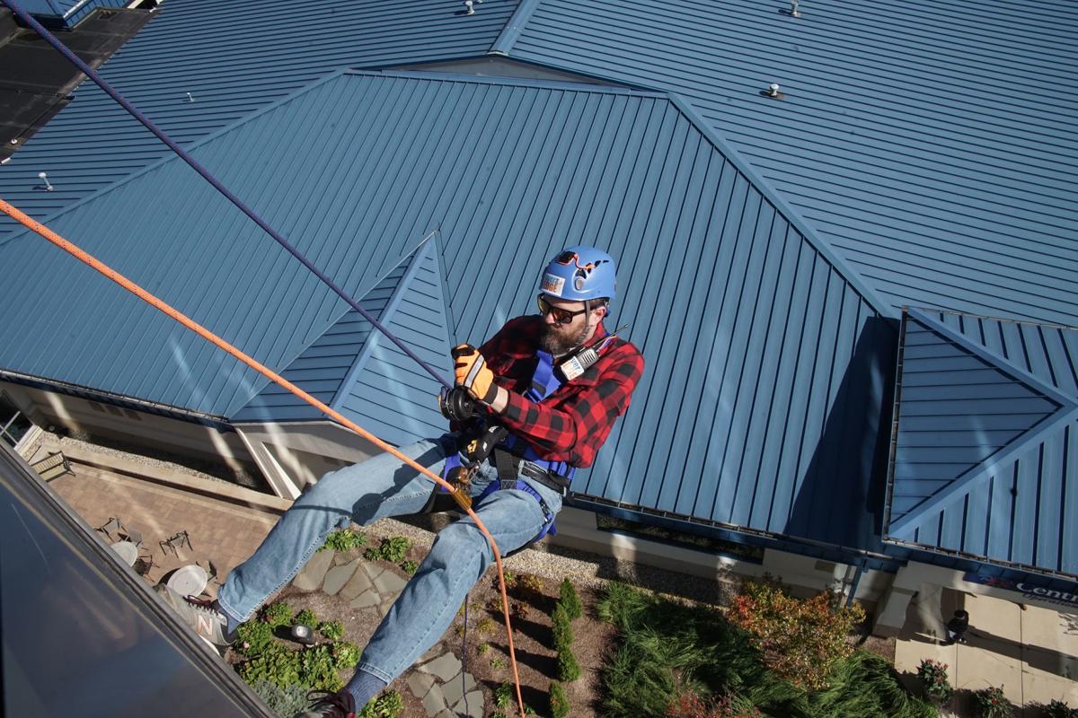Over the Edge Centier bank tower rappelling raised $65,000 for working families