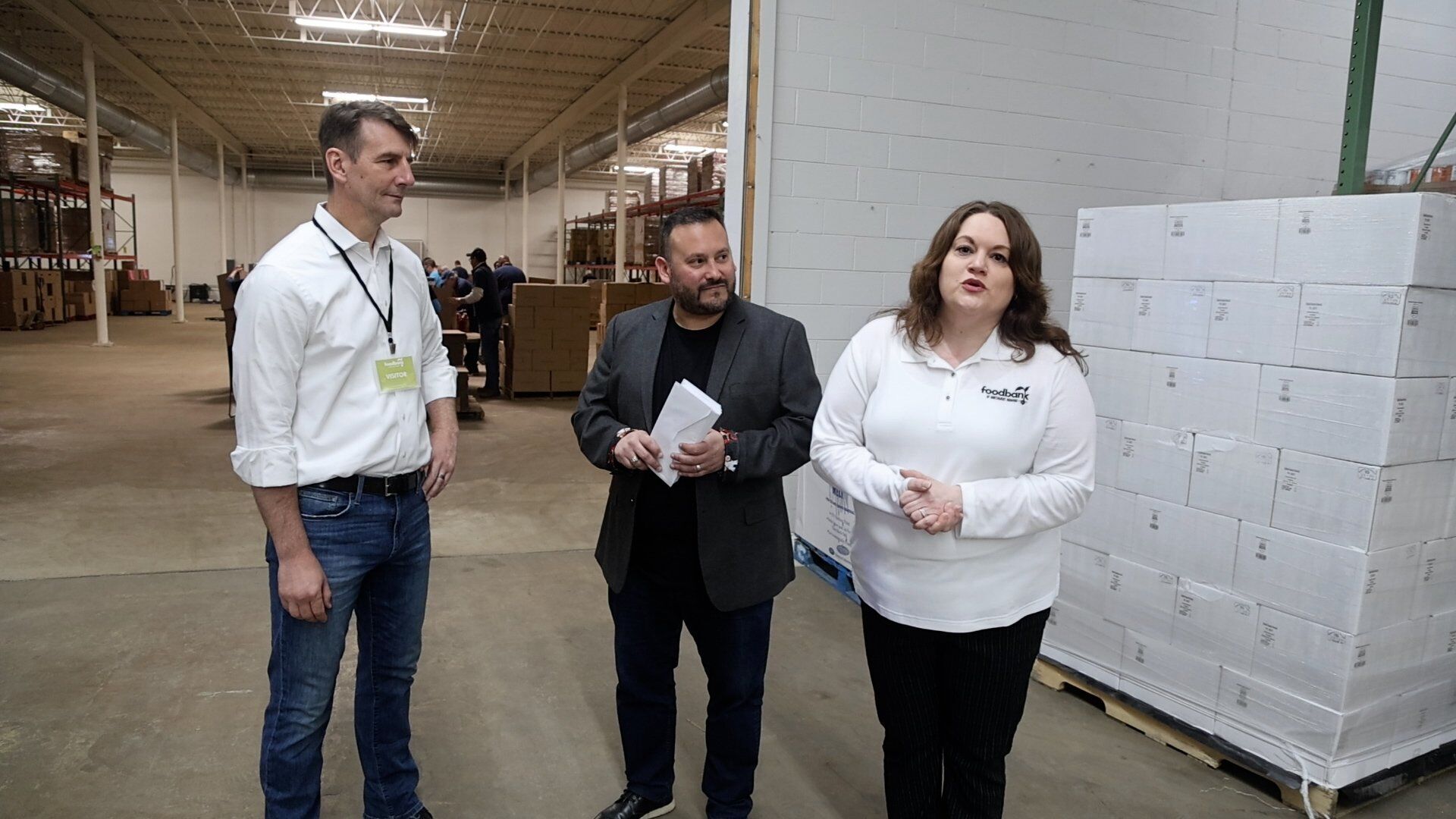 Amy Briseno and Victor Garcia from the Northwest Indiana Food Bank present letters from constituents to US Rep. Frank Mrvan