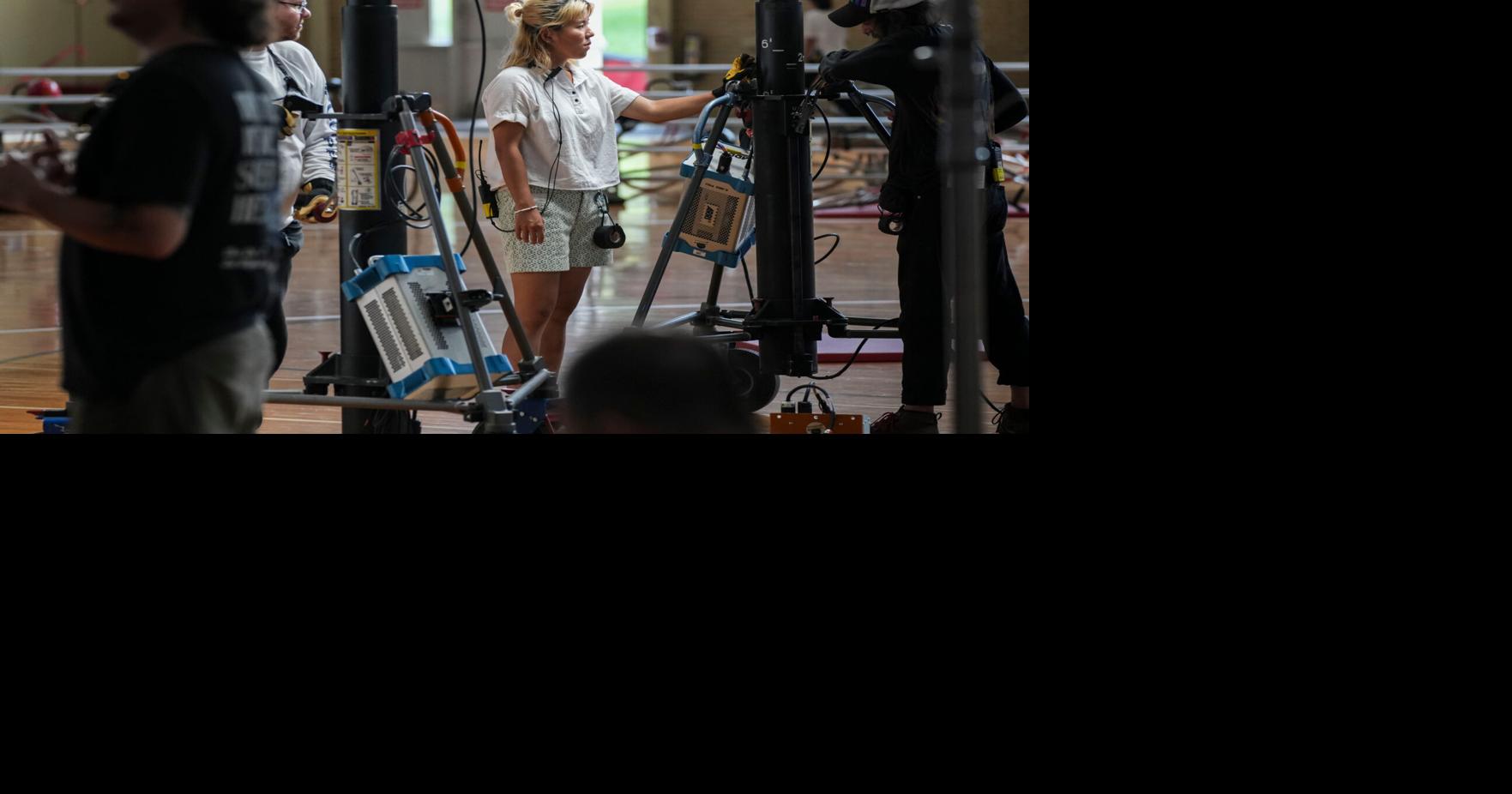 Crew members work Tuesday, Aug. 11, 2026, during filming at Bill Garrett Fieldhouse in Bloomington, Ind.