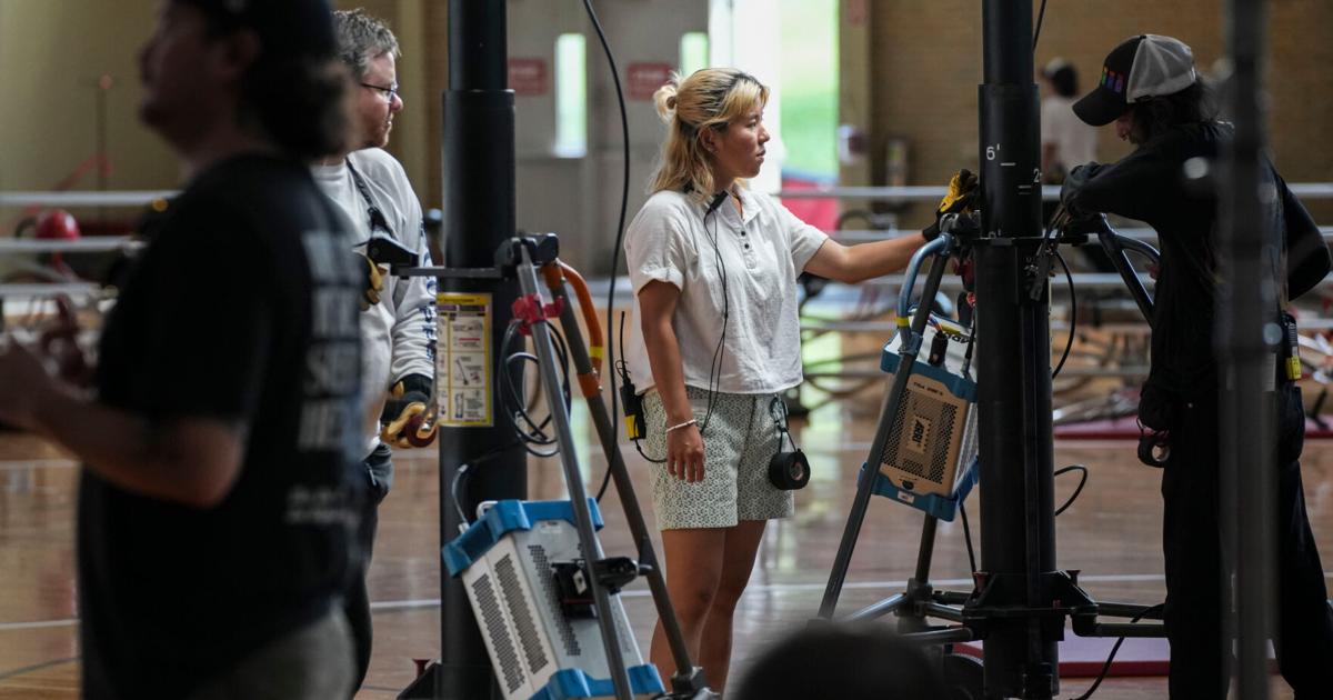 Crew members work Tuesday, Aug. 11, 2026, during filming at Bill Garrett Fieldhouse in Bloomington, Ind.