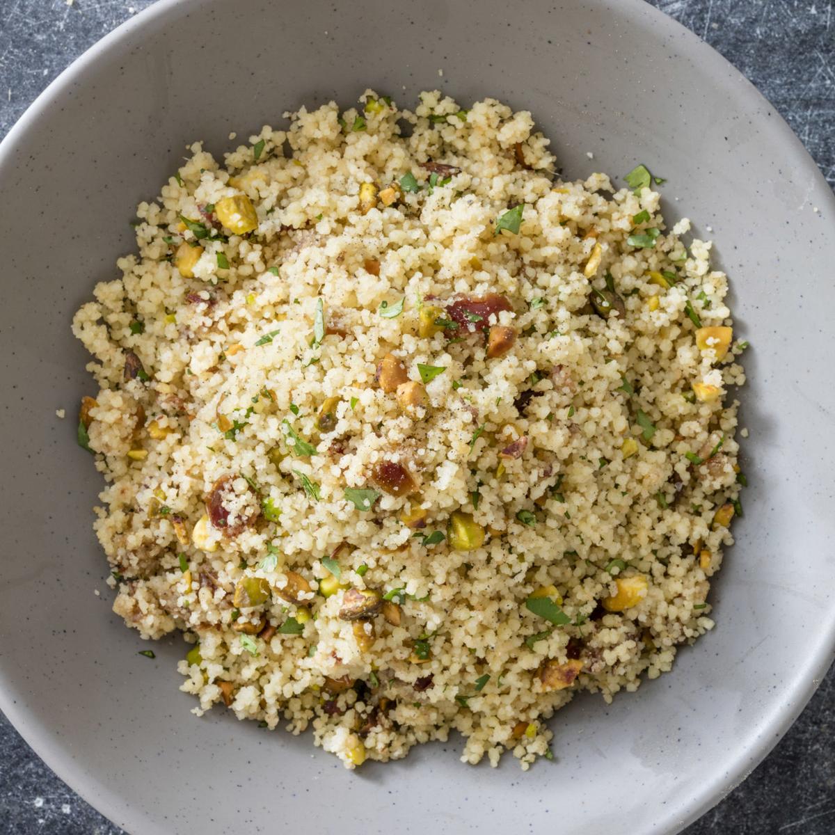 Toasting couscous grains and using broth deepens the flavor