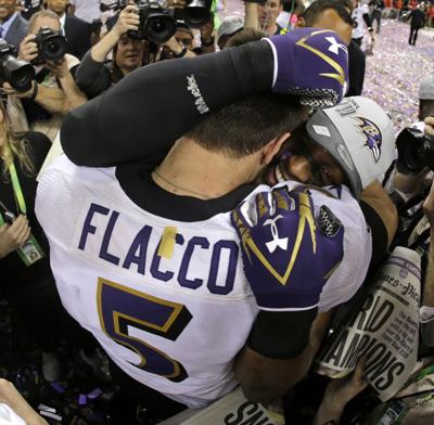 Former Baltimore Ravens linebacker Ray Lewis, left, arrives with