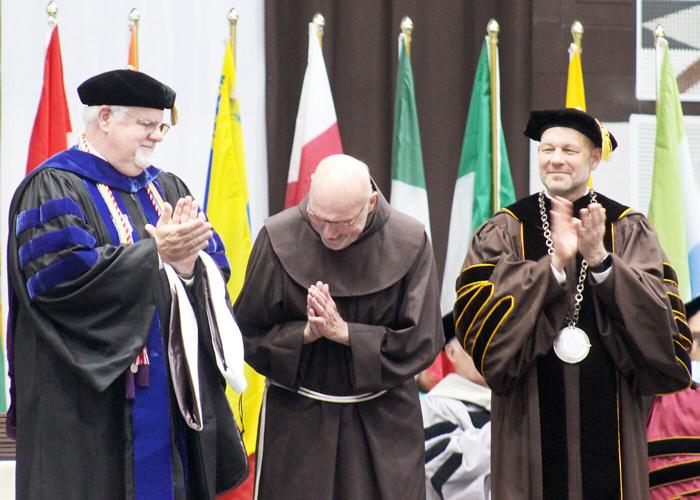 Fr. Riley honored with doctorate, surprise Schumer speech at St