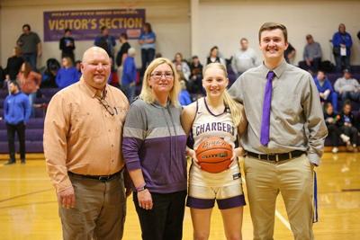 Coaches Jeremy Chicoine, Susie Rilling and Conner Decker celebrate with Stevie Wittler her 1000th career point.