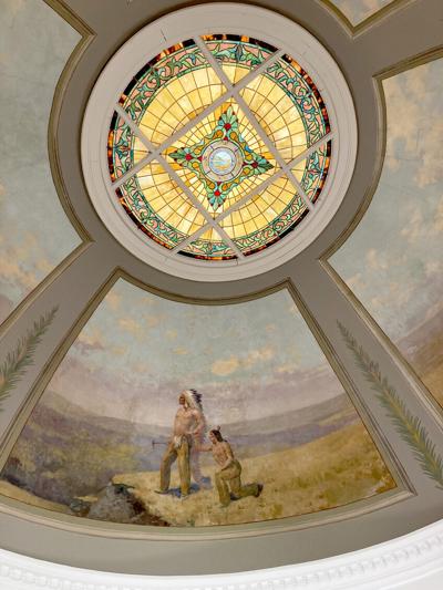 The Great Seal of the State of South Dakota takes center stage in the restored stained glass in the courthouse dome. Four murals surrounding the glass depict scenes from Sully County’s founding days, including this painting of a pair of Native Americans.