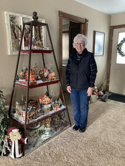 Patty McGee is pictured with the Christmas village - and village courthouse - she has displayed in her home.