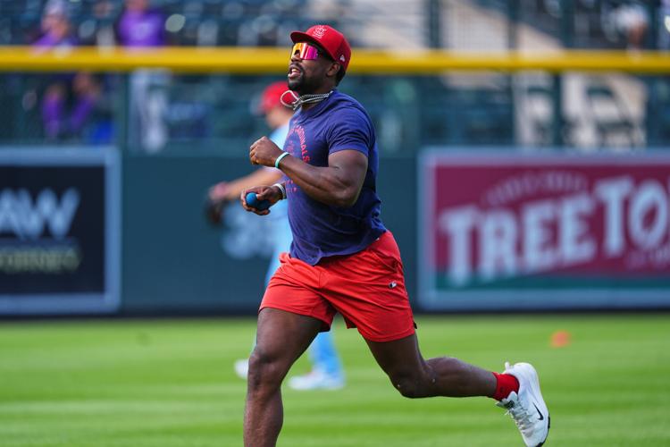 Cardinals, Rockies players tilt caps a day after umpire Eddings
