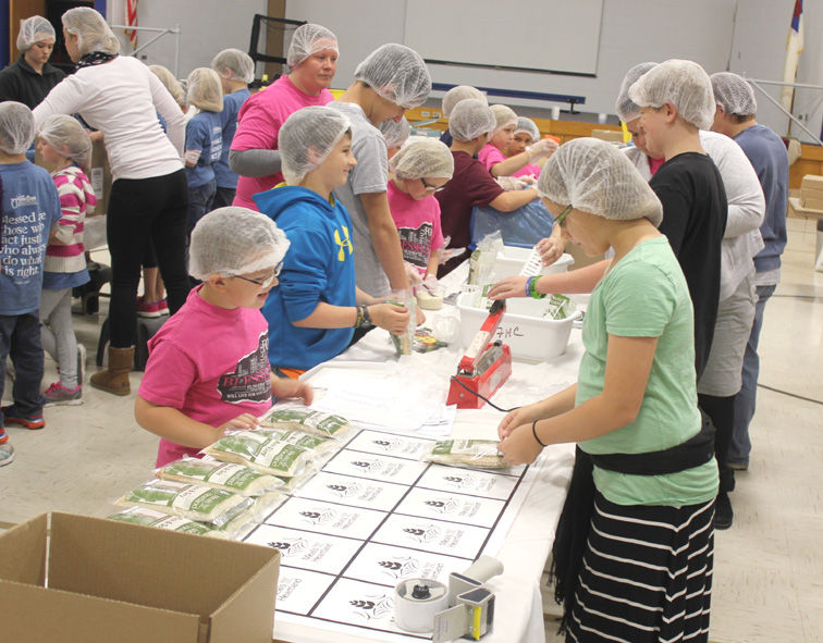 Christian School students package food for Meals from the Heartland