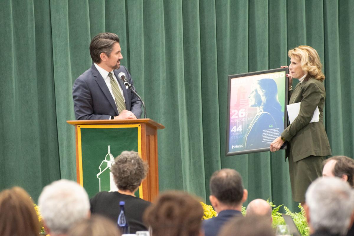 SUNY Chancellor Jim Malatras gifts a picture to outgoing SUNY Oswego President Deborah Stanley