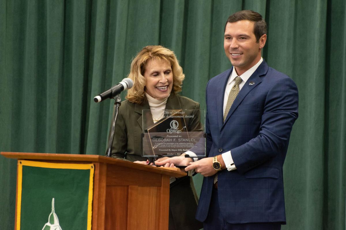 Oswego Mayor Billy Barlow presents SUNY Oswego President Deborah Stanley with award