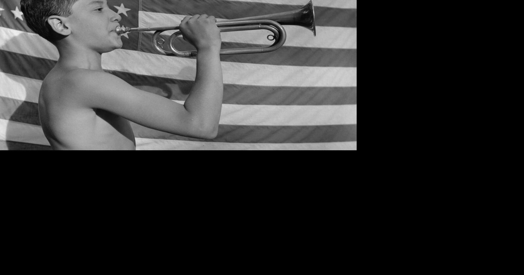 A camper blows a bugle at Camp Nathan Hale in upstate New York in 1943.