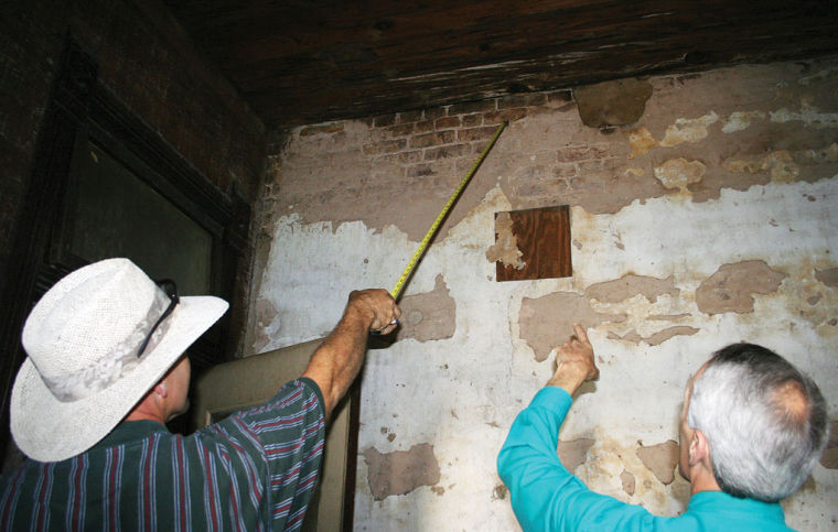 Bat Removal Slows Renovation Of Historic Gregg Link Building Local Wood Restoration Contractor Paul Priestner Uses His Measuring Tape To Point Entry Spots Used By Bats Over The Years In Gregg Link Building