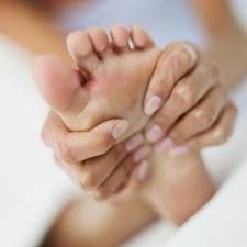 woman massaging the ball of her foot