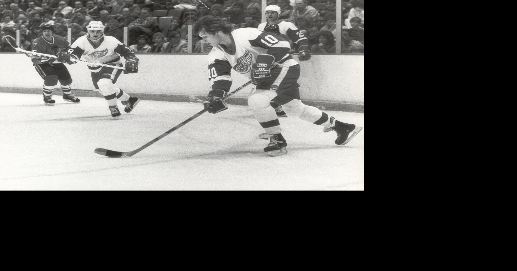 Detroit Red Wings' Ron Duguay with the puck, with Steve Yzerman at left.